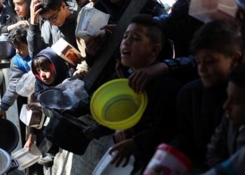 Orang-orang menunggu untuk menerima bantuan makanan di kota Rafah di Jalur Gaza selatan.