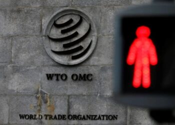 FILE PHOTO: A red light is pictured at a pedestrian crossing in front of the World Trade Organization headquarters in Geneva, Switzerland, December 9, 2019.